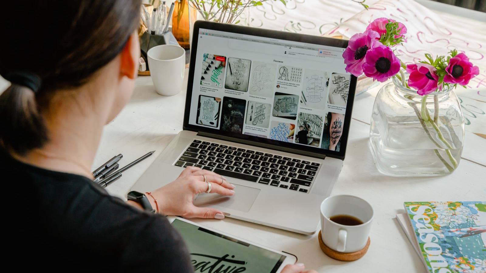 A person working on a design layout on a laptop screen