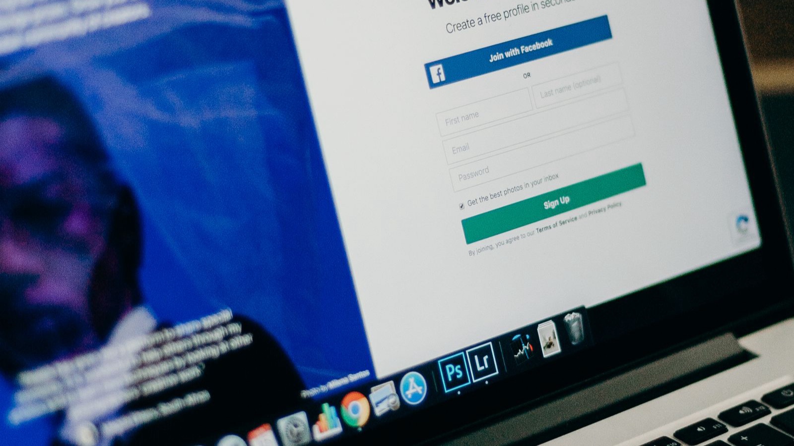 Close-up view of a laptop displaying a sign-up page for an online platform.