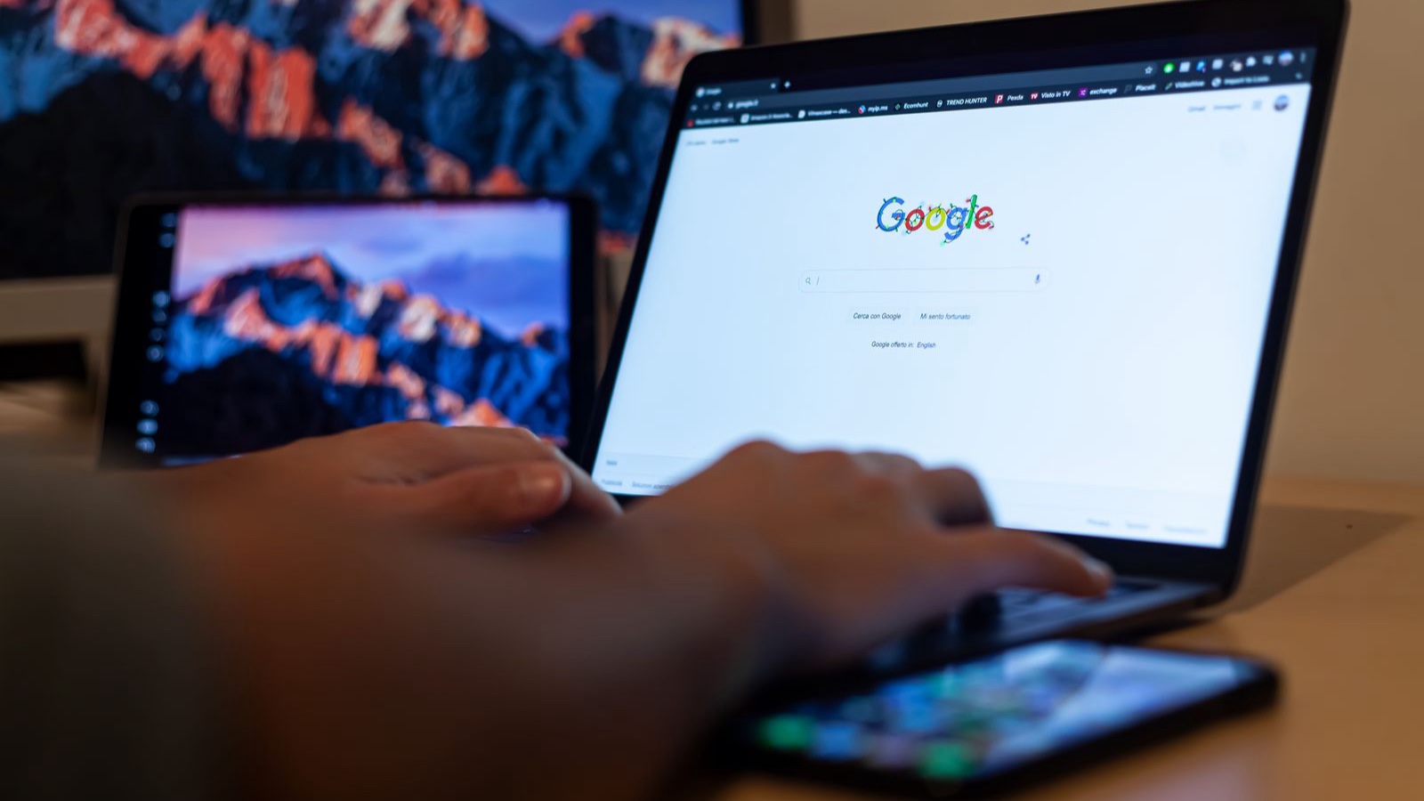 Google Ads keyword research: Intent matters alongside volume Hands typing on a laptop with Google on screen, in a remote work setup in Milan, Italy.