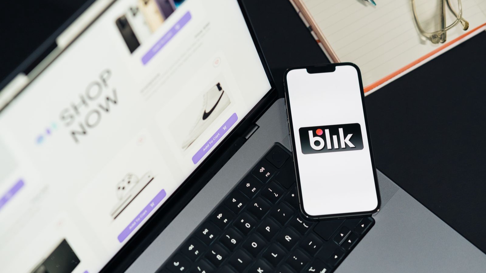 Online store on a laptop beside a phone displaying a payment option