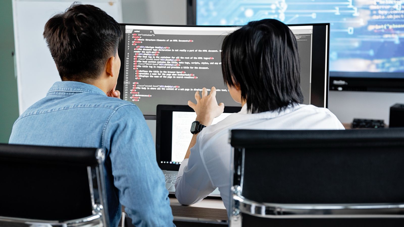 Packaged or Custom Software? Build a Decision Matrix That Helps Two people reviewing work on a computer screen