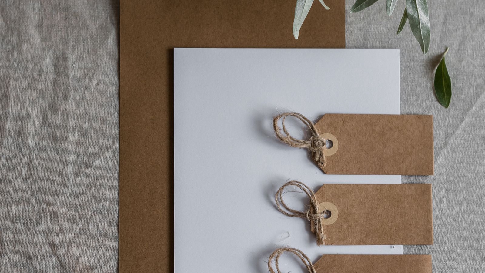 String-tied product tags and printed papers on a cardboard folder