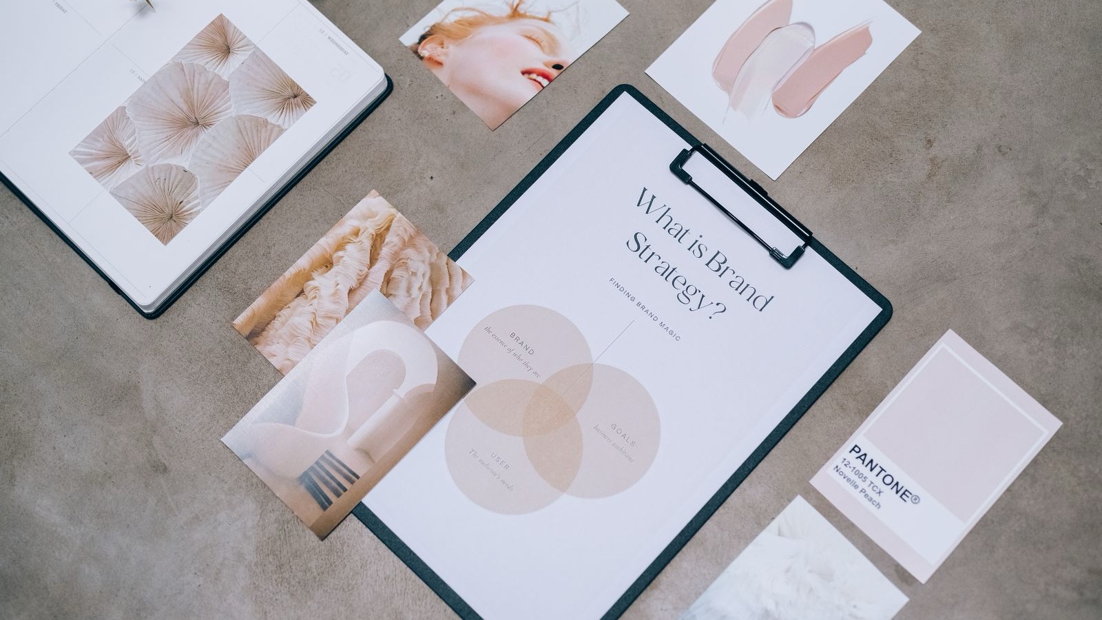 Brand strategy document, colour samples and visual references on a table