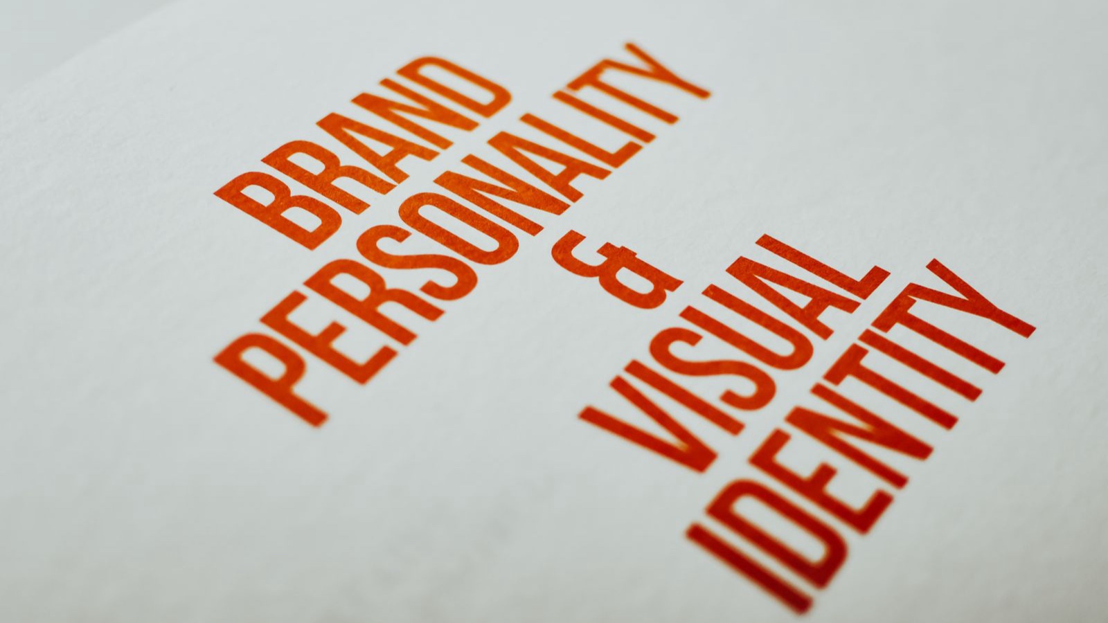 Orange brand personality and visual identity heading on white paper