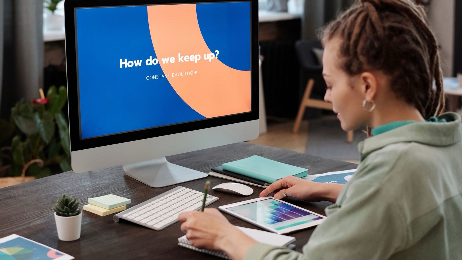 A person editing a design on a computer using a graphics tablet