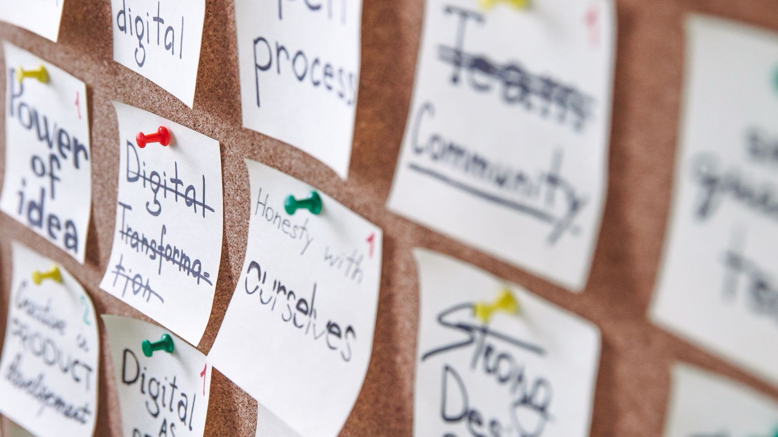 Colourful idea notes organised on a cork board
