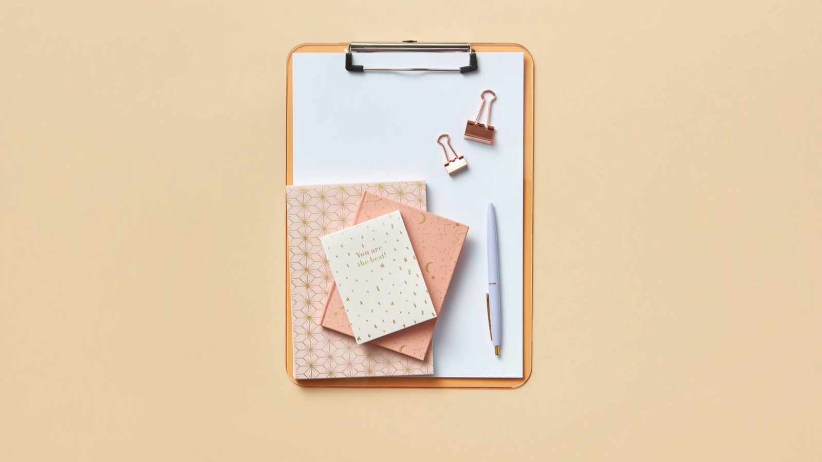 Notebooks and a pen on a clipboard ready for writing