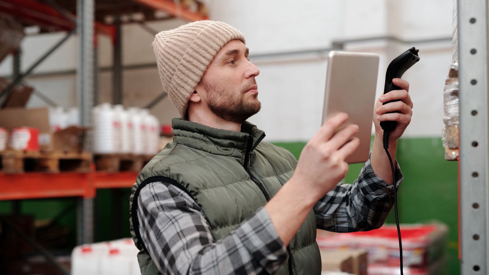Warehouse worker checking stock with a handheld terminal