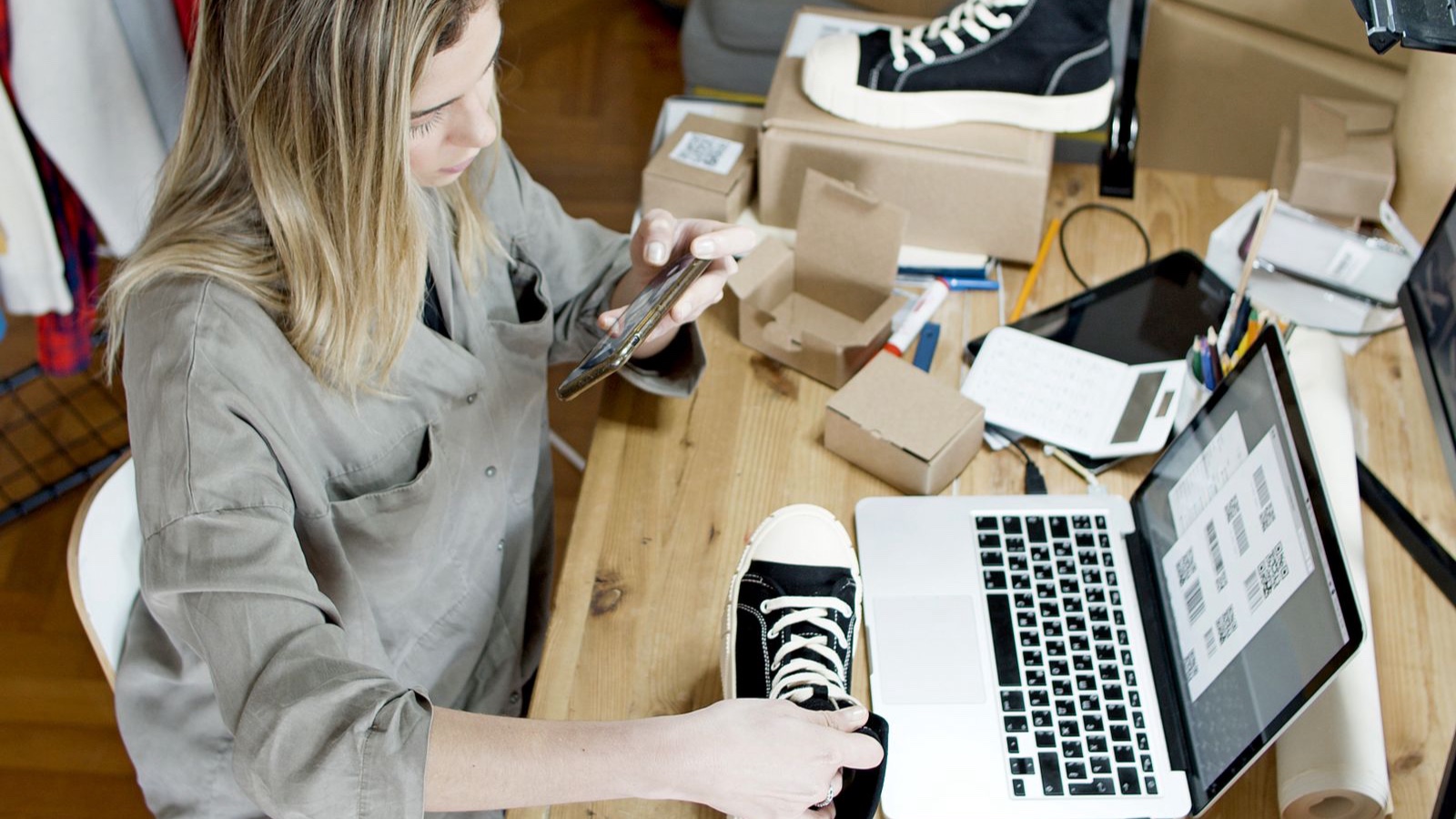 Online seller preparing a product photograph of a sneaker