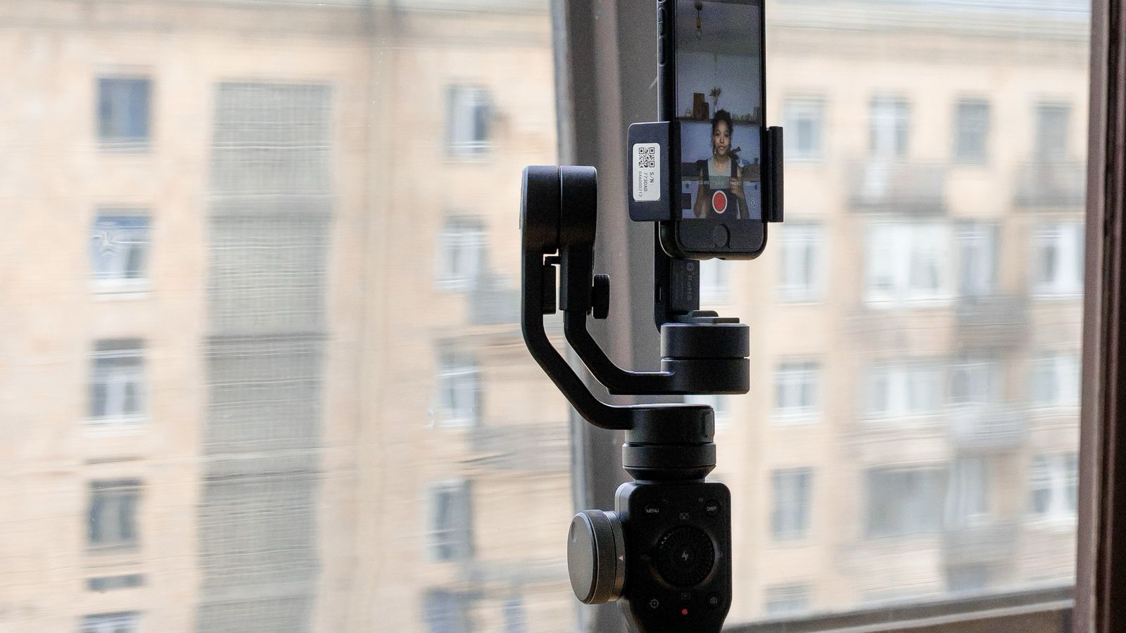 A Filming Brief for Social Media: Prevent Missing Information and Footage A smartphone mounted on a tripod beside a window
