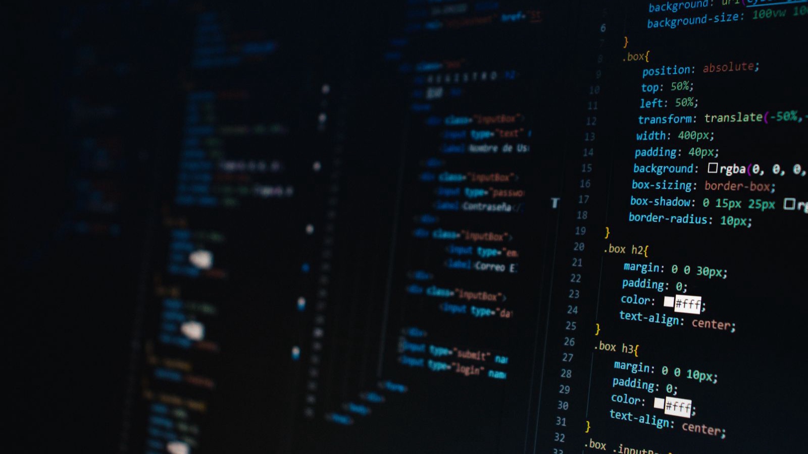 Detailed view of HTML and CSS code on a dark screen, representing modern web development.